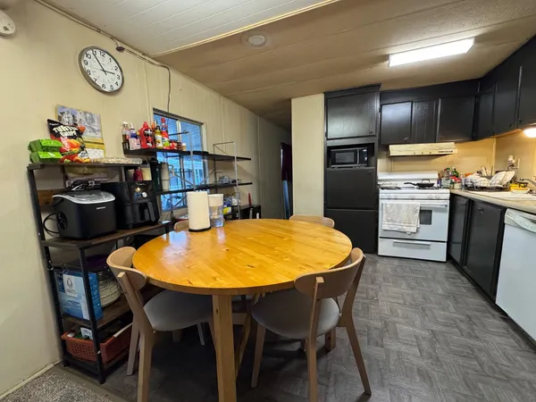 a kitchen with a table and chairs in it