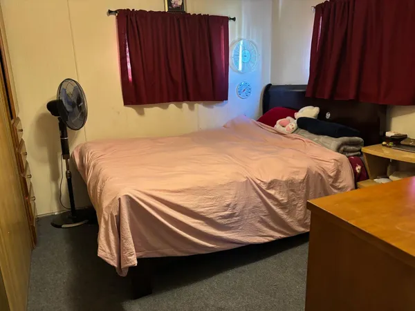 a bedroom with a bed and a dresser