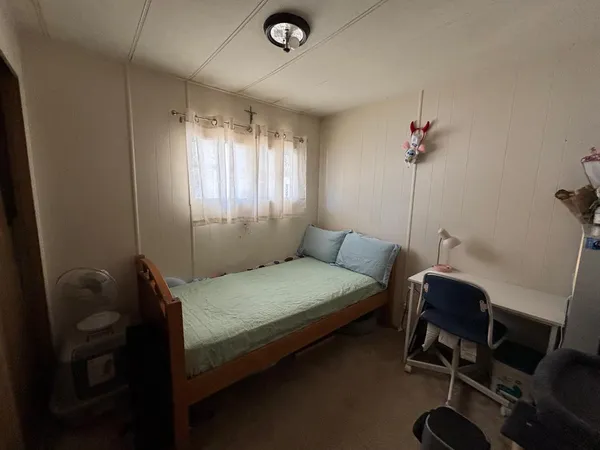 a bedroom with a bed and a window