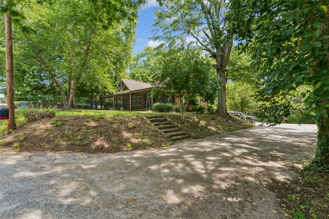 321 South Pine Street Walhalla, SC 29691 - Photo 31 of 32 Mature trees frame this inviting property with a charming screened porch, perfect for outdoor living.