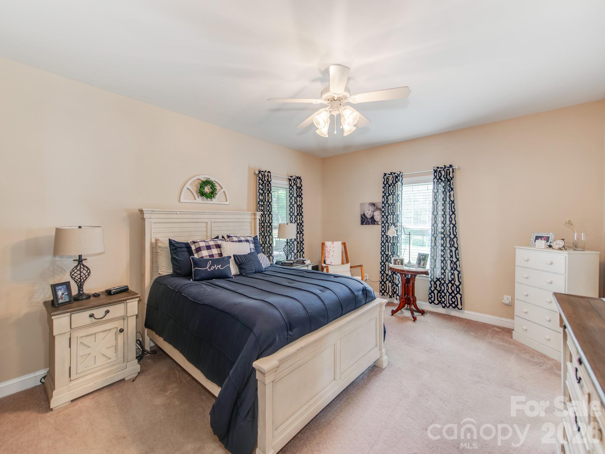 2261 Stallings Road Harrisburg, NC 28075 - Photo 19 of 41 a bedroom with a bed and a chandelier