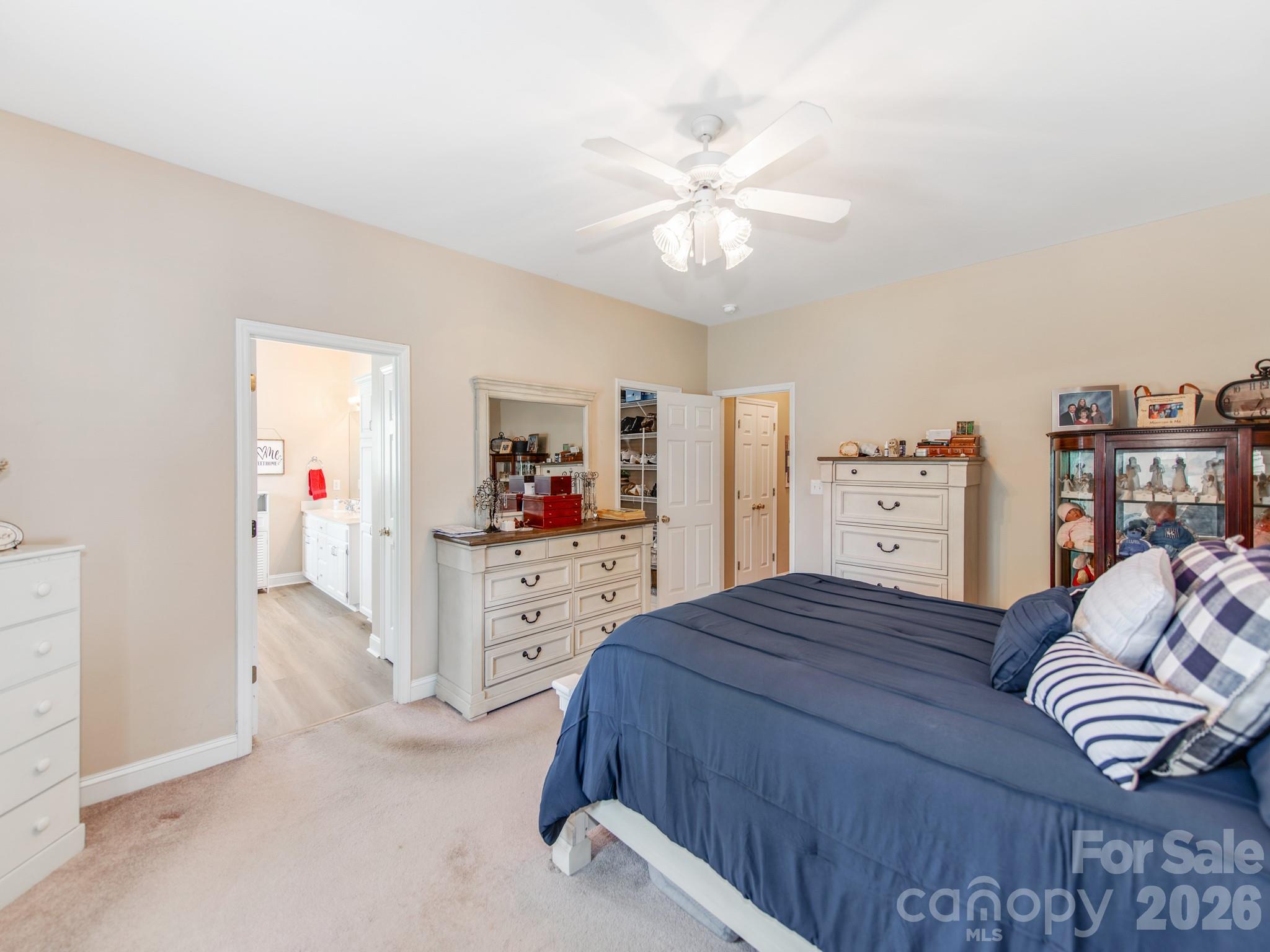 2261 Stallings Road Harrisburg, NC 28075 - Photo 20 of 41 a bedroom with a bed and a chandelier