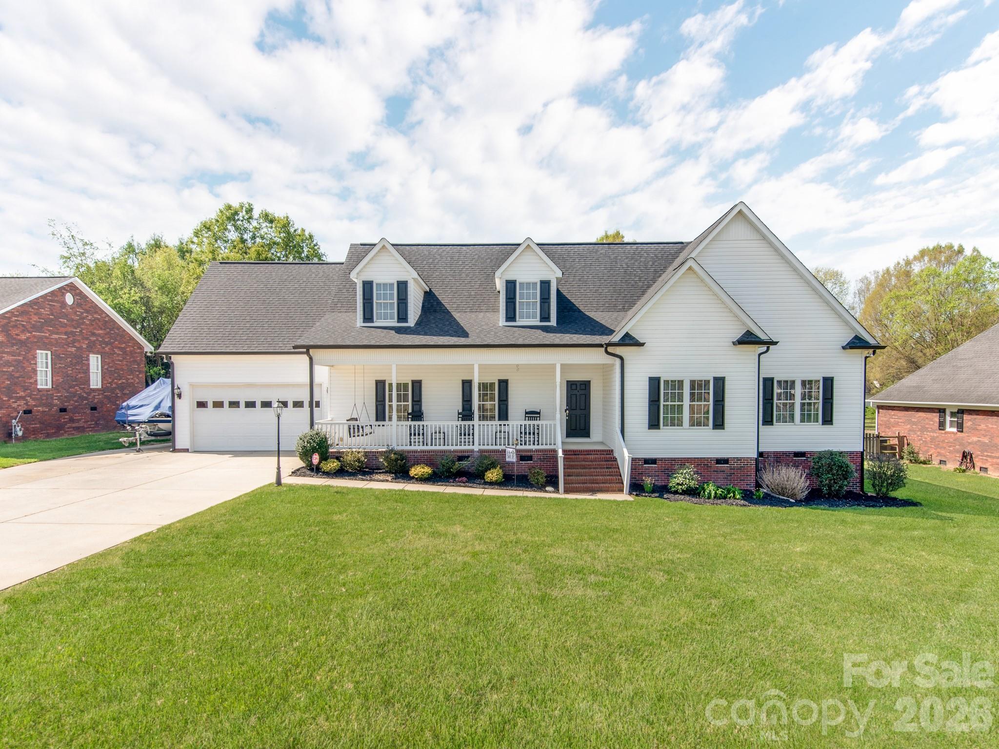 2261 Stallings Road Harrisburg, NC 28075 - Photo 2 of 41 a front view of a house with a garden and trees