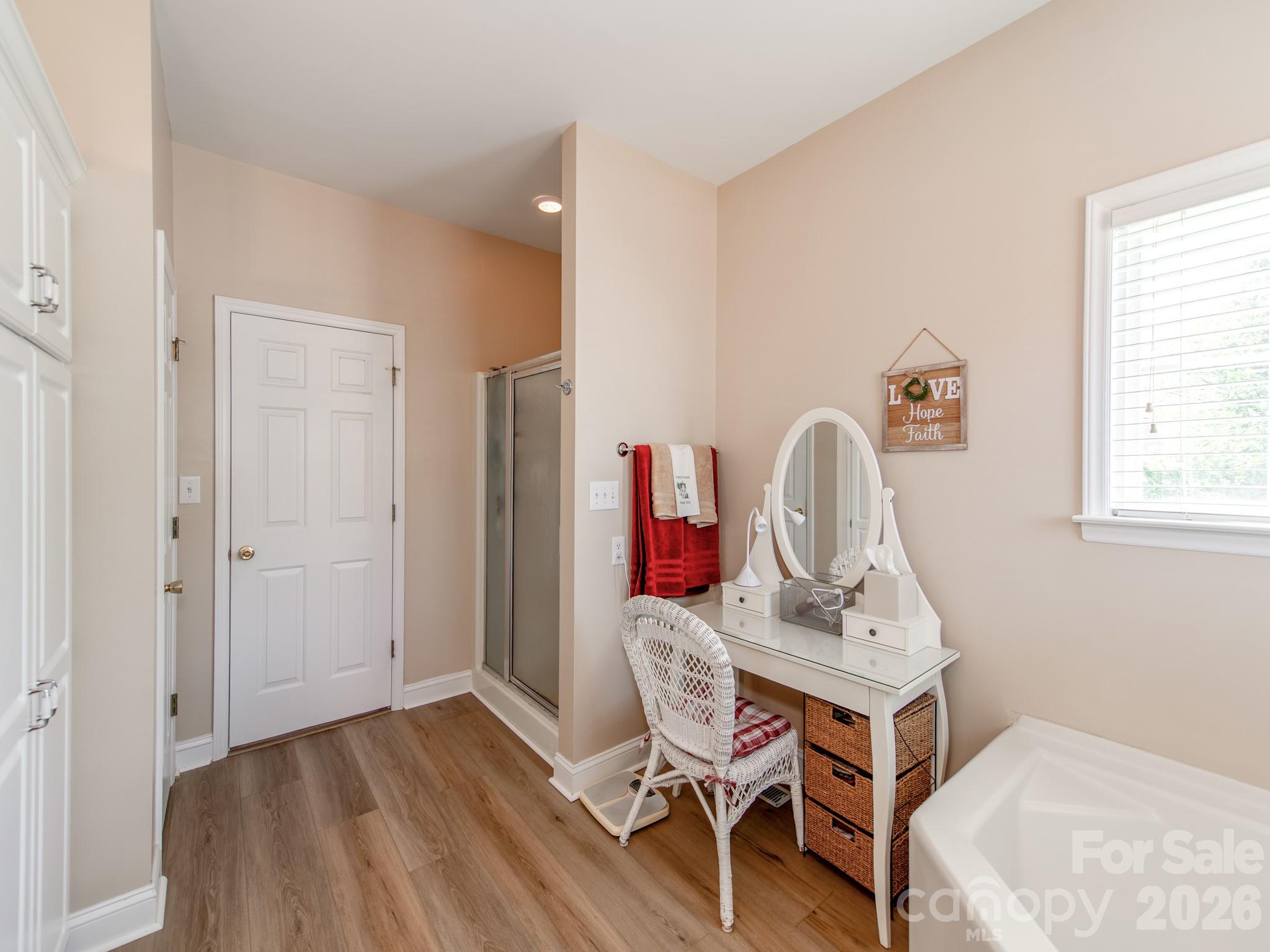 2261 Stallings Road Harrisburg, NC 28075 - Photo 22 of 41 a workspace with furniture and wooden floor