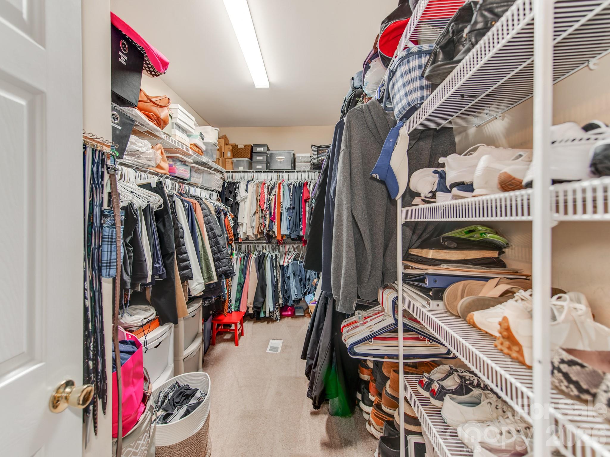 2261 Stallings Road Harrisburg, NC 28075 - Photo 23 of 41 a view of walk in closet with clothes and shoes