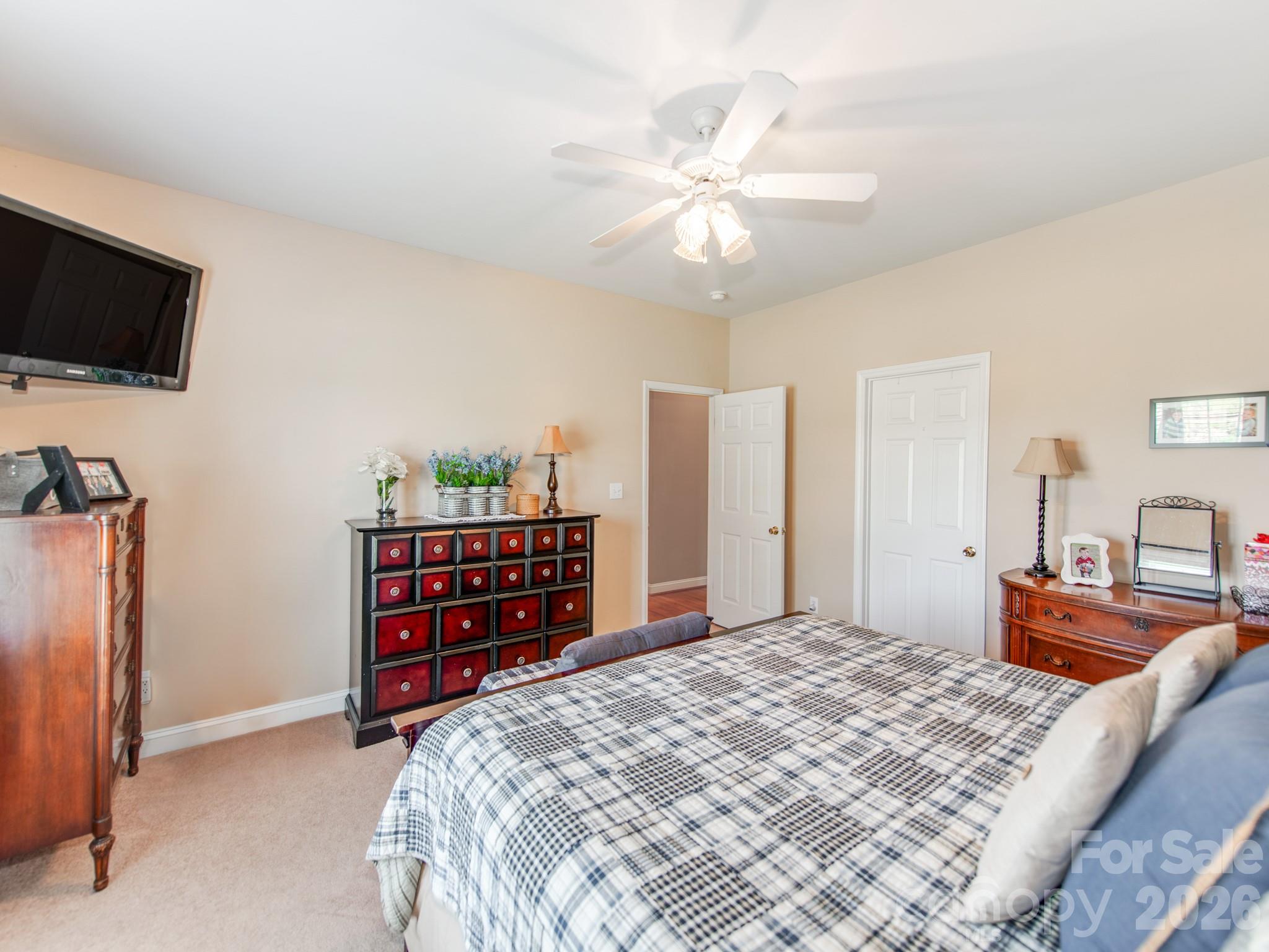 2261 Stallings Road Harrisburg, NC 28075 - Photo 25 of 41 a bedroom with a bed and a flat screen tv