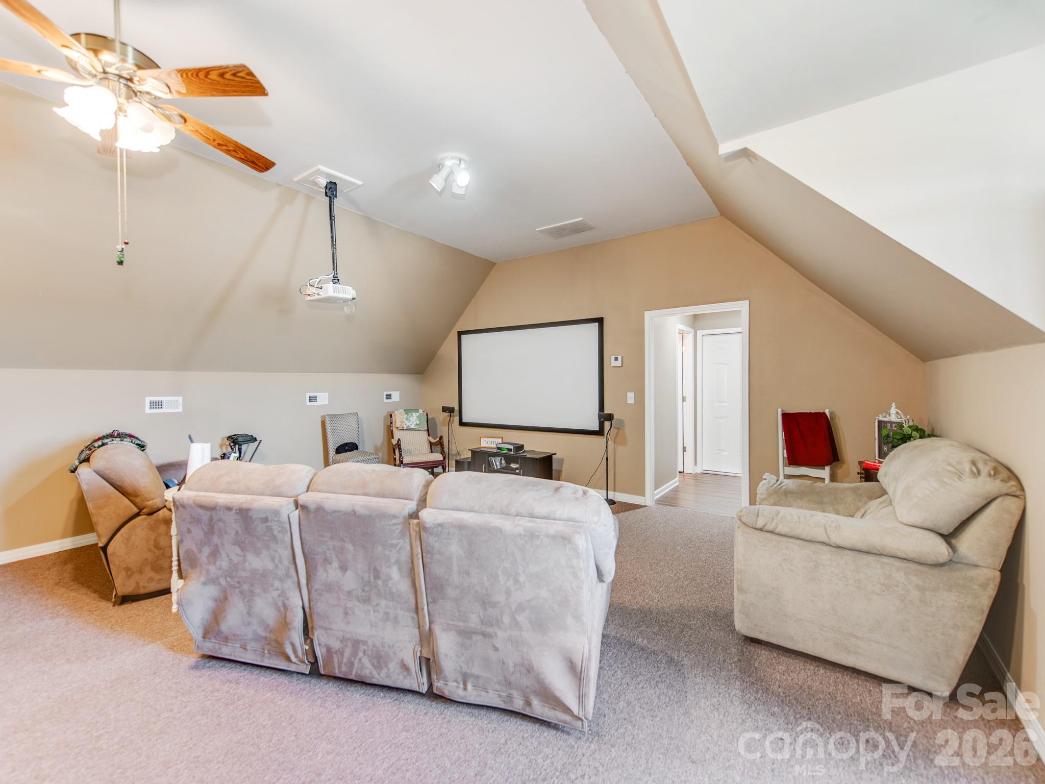 2261 Stallings Road Harrisburg, NC 28075 - Photo 31 of 41 a living room with furniture a ceiling fan and a rug