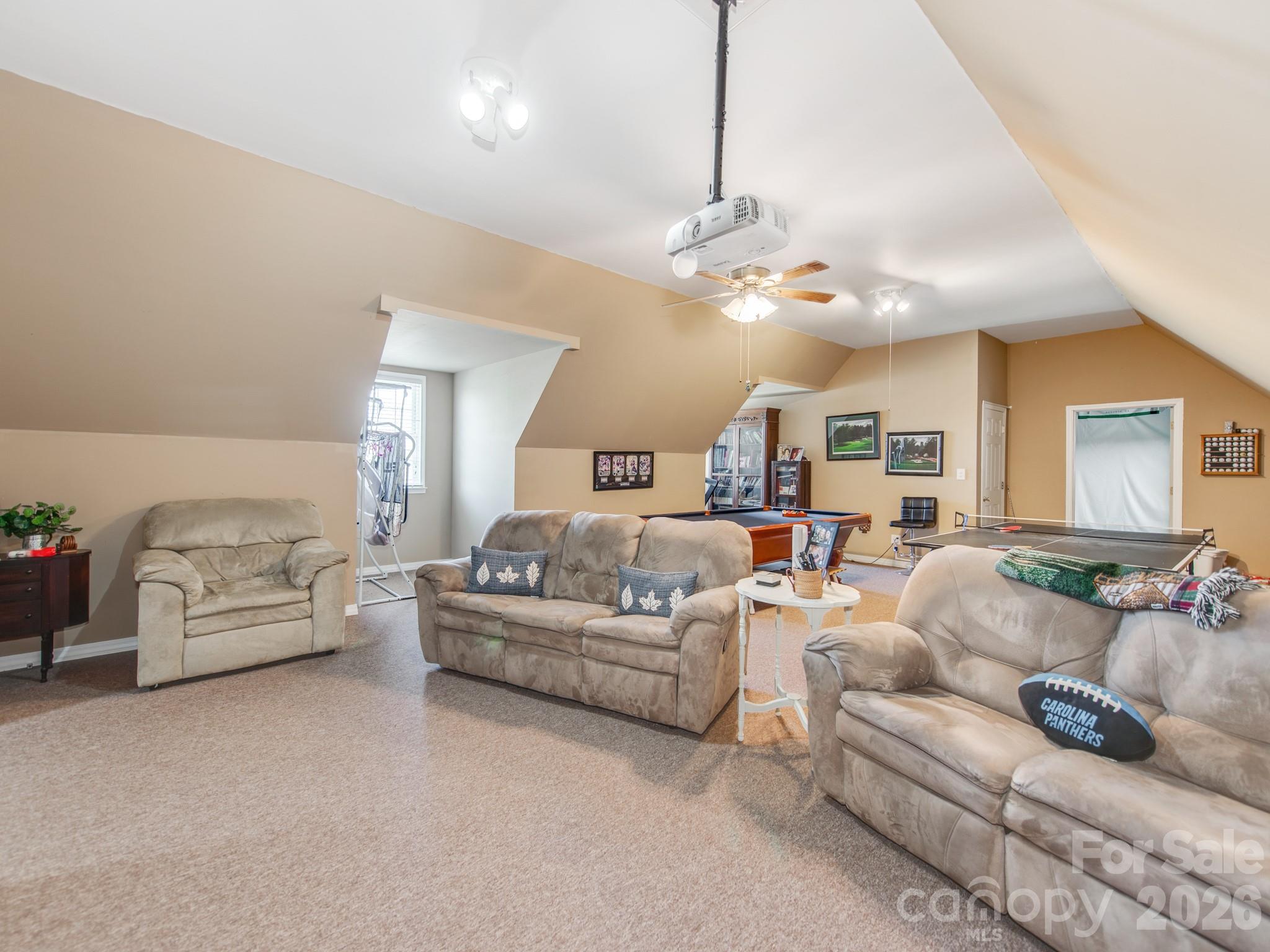 2261 Stallings Road Harrisburg, NC 28075 - Photo 32 of 41 a living room with furniture and a chandelier