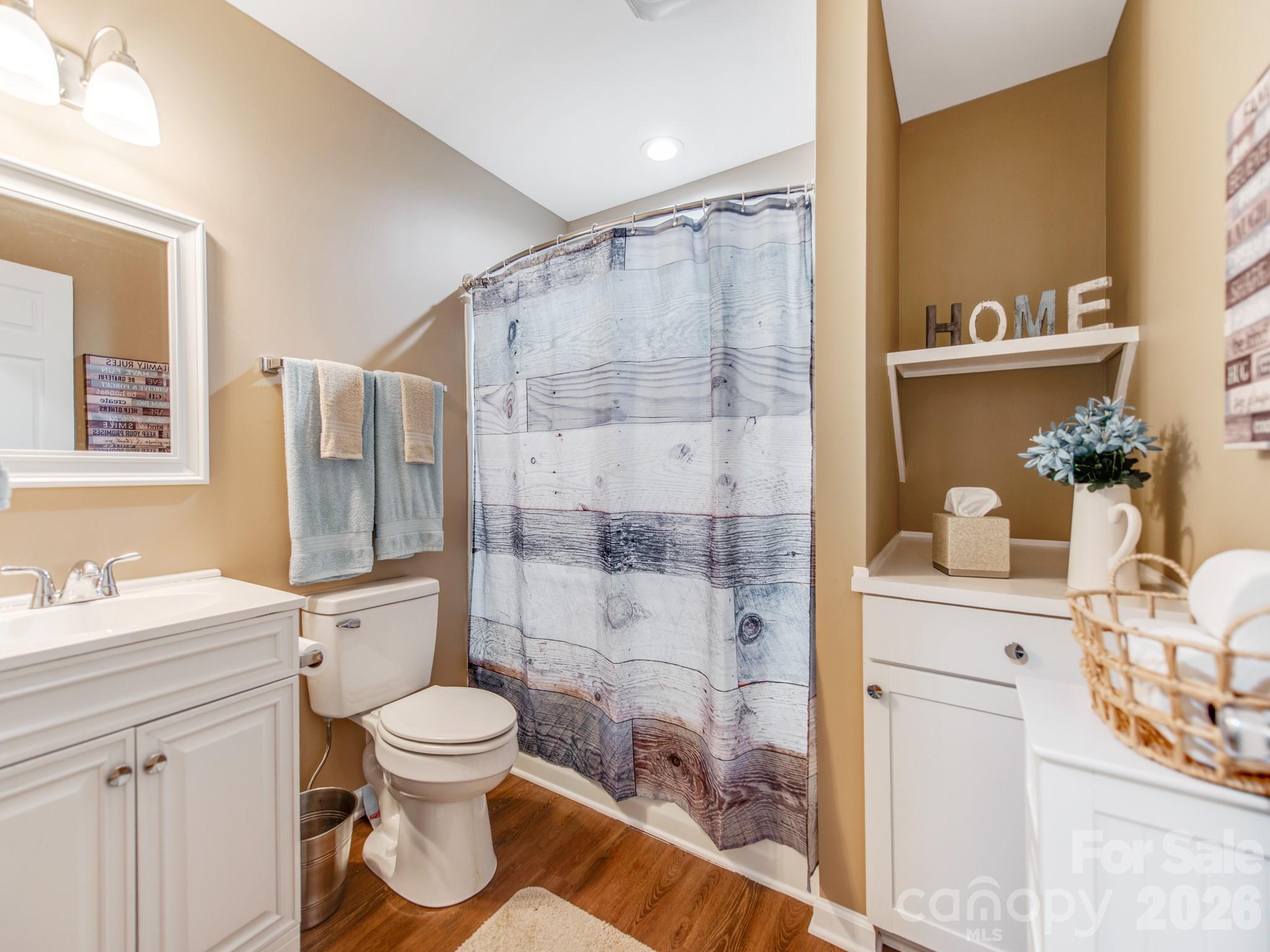 2261 Stallings Road Harrisburg, NC 28075 - Photo 33 of 41 a bathroom with a toilet sink vanity granite and shower