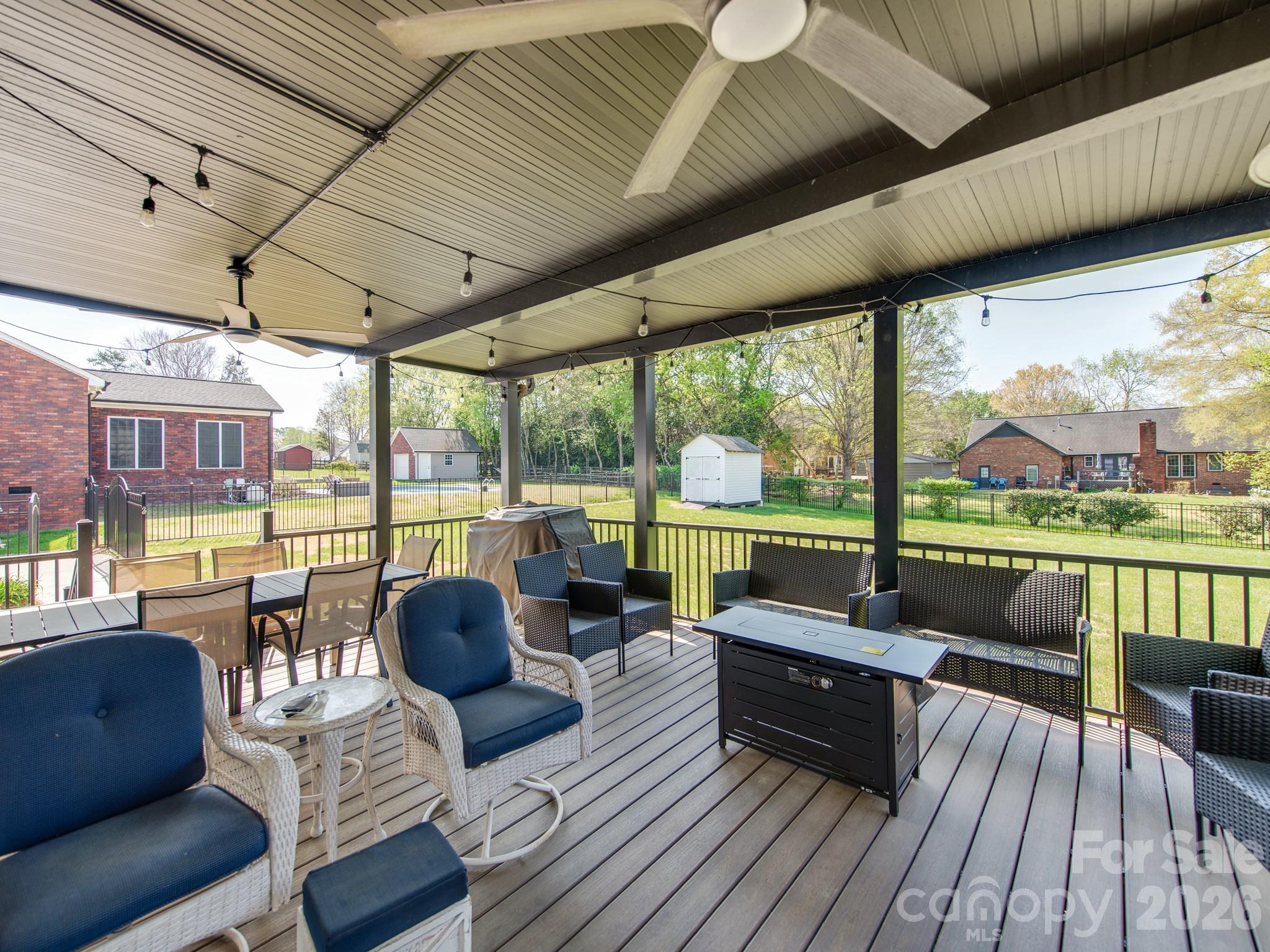 2261 Stallings Road Harrisburg, NC 28075 - Photo 7 of 41 a living room with patio furniture and a floor to ceiling window