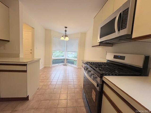 1 Spring Pond Drive Ossining, NY 10562 - Photo 5 of 17 a kitchen with a stove and a microwave