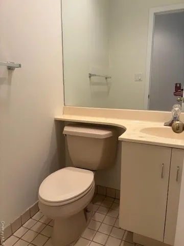 a white toilet sitting next to a bathroom sink