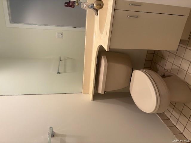 1 Spring Pond Drive Ossining, NY 10562 - Photo 9 of 17 a white toilet sitting next to a bathroom sink