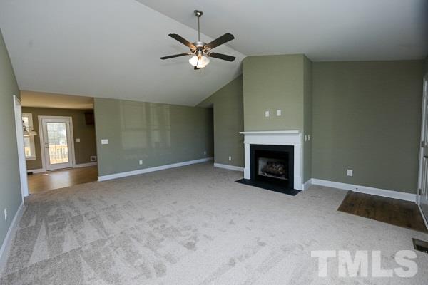 100 Hunters Point Court Angier, NC 27501 - Photo 2 of 13 a view of an empty room with chandelier fan and fire place