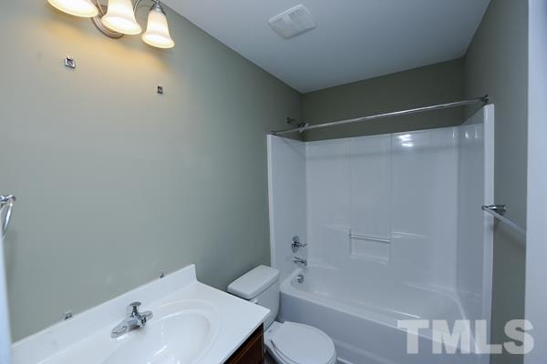 100 Hunters Point Court Angier, NC 27501 - Photo 11 of 13 a bathroom with a bathtub shower sink vanity and toilet