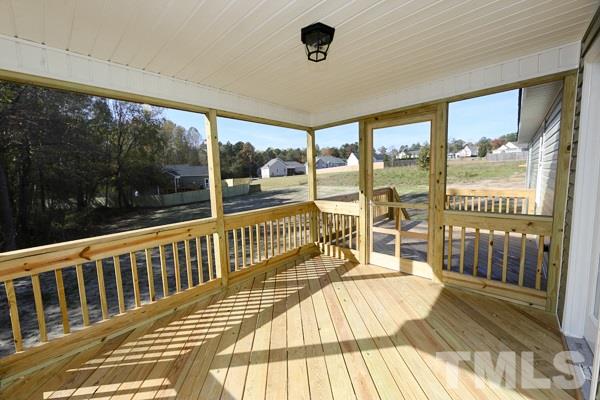 100 Hunters Point Court Angier, NC 27501 - Photo 12 of 13 a view of a balcony with a floor to ceiling window wooden floor