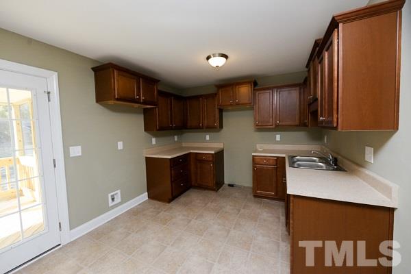 100 Hunters Point Court Angier, NC 27501 - Photo 4 of 13 a kitchen with stainless steel appliances granite countertop a sink stove microwave and refrigerator