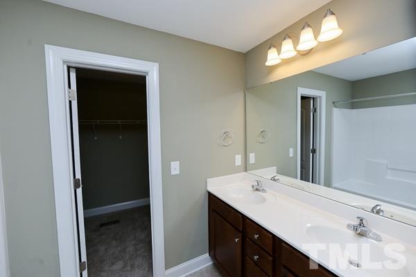100 Hunters Point Court Angier, NC 27501 - Photo 7 of 13 a bathroom with a double vanity sink and a mirror