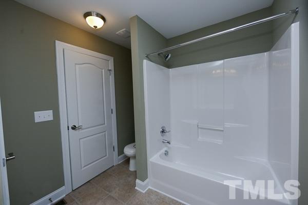 100 Hunters Point Court Angier, NC 27501 - Photo 8 of 13 a bathroom with a bathtub and a shower