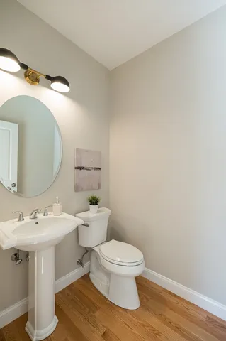 a white toilet sitting next to a bathroom sink