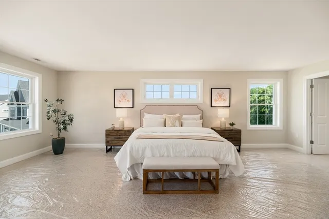 a spacious bedroom with a bed and a couch