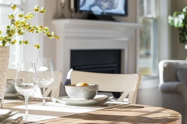 a living room with a fireplace and flowers