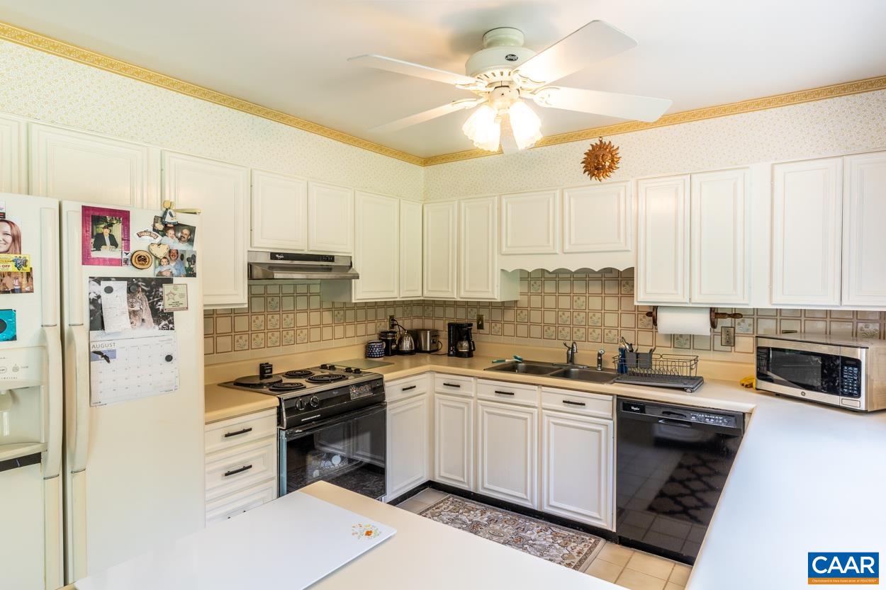 2705 Huntington Road Charlottesville, VA 22901 - Photo 7 of 27 a kitchen with white cabinets and white appliances