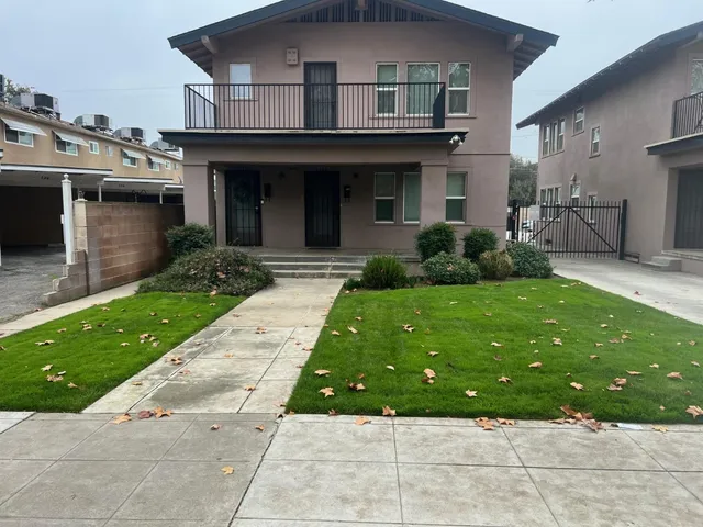 a front view of a house with a garden