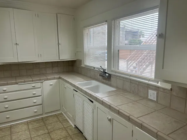a kitchen with a sink and cabinets
