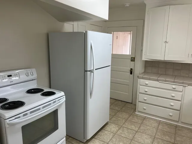 a kitchen with a stove and a refrigerator
