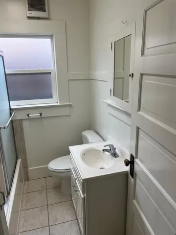 a bathroom with a sink toilet and mirror