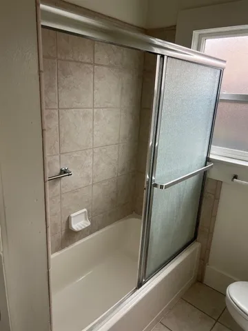a bathroom with a shower and a toilet