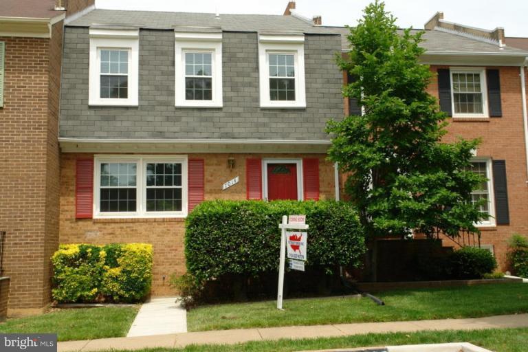 7014 Leestone Street Springfield, VA 22151 - Photo 1 of 23 a view of a brick house with a yard and large tree