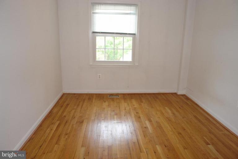 7014 Leestone Street Springfield, VA 22151 - Photo 12 of 23 an empty room with wooden floor and windows