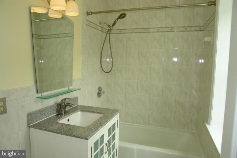 7014 Leestone Street Springfield, VA 22151 - Photo 15 of 23 a bathroom with a sink and a shower