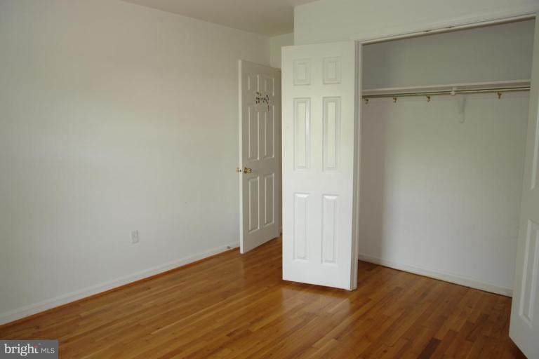 7014 Leestone Street Springfield, VA 22151 - Photo 17 of 23 a view of an empty room with wooden floor and a window