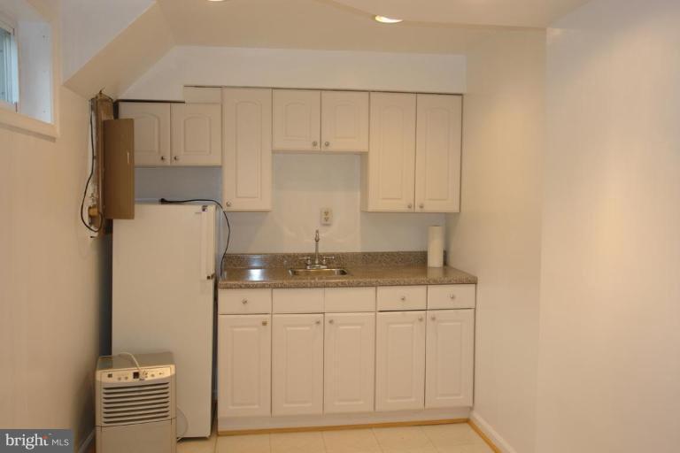7014 Leestone Street Springfield, VA 22151 - Photo 18 of 23 a kitchen with a sink a refrigerator and cabinets