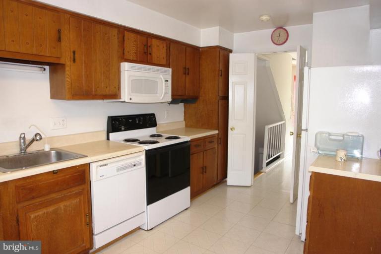 7014 Leestone Street Springfield, VA 22151 - Photo 3 of 23 a kitchen with stainless steel appliances granite countertop a sink stove and refrigerator
