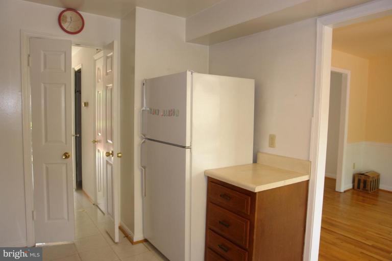 7014 Leestone Street Springfield, VA 22151 - Photo 4 of 23 a kitchen with a refrigerator and a sink