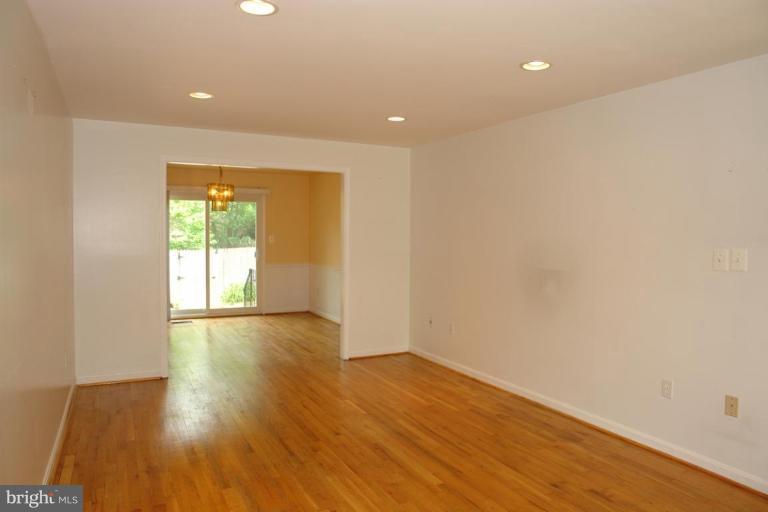 7014 Leestone Street Springfield, VA 22151 - Photo 6 of 23 a view of an empty room with wooden floor and a window