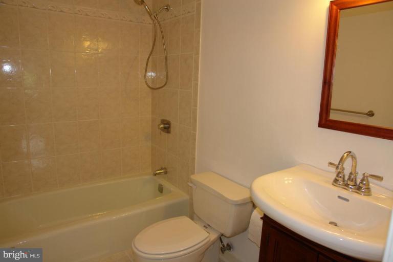 7014 Leestone Street Springfield, VA 22151 - Photo 10 of 23 a bathroom with a sink toilet and shower