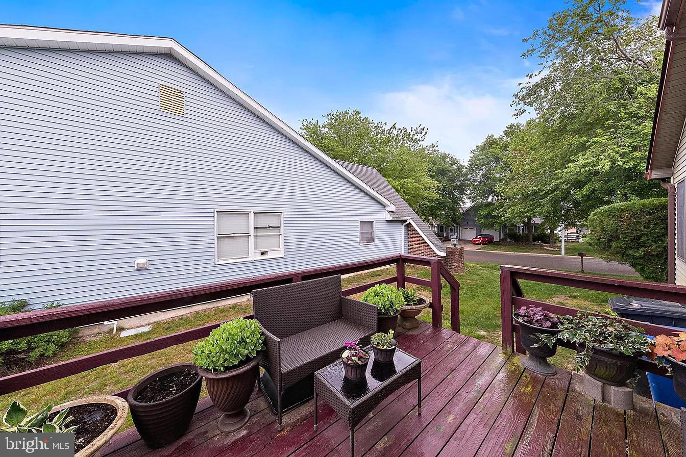 22 Fir Road Manahawkin, NJ 08050 - Photo 32 of 35 a backyard of a house with wooden floor outdoor seating and yard in the back
