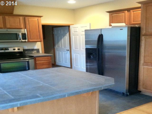 620 Southwest Trout Court Camas, WA 98607 - Photo 4 of 8 a kitchen with stainless steel appliances granite countertop a refrigerator and a stove