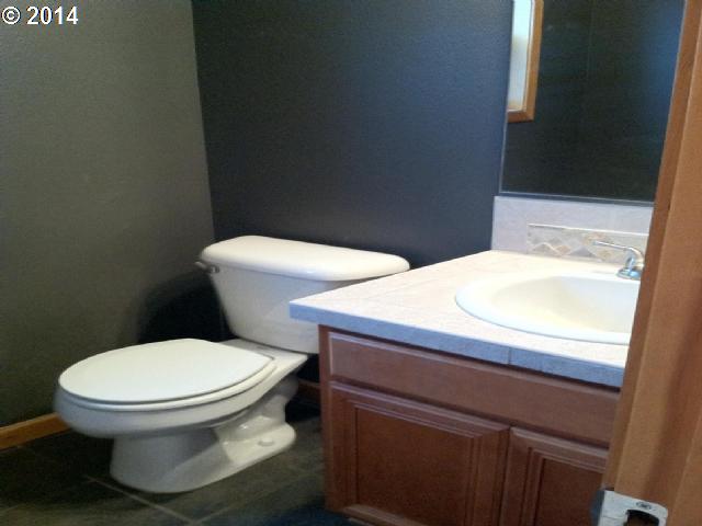 620 Southwest Trout Court Camas, WA 98607 - Photo 7 of 8 a white toilet sitting next to a bathroom sink