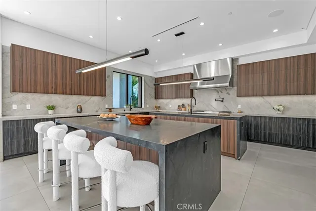 a kitchen with stainless steel appliances kitchen island granite countertop a sink and cabinets