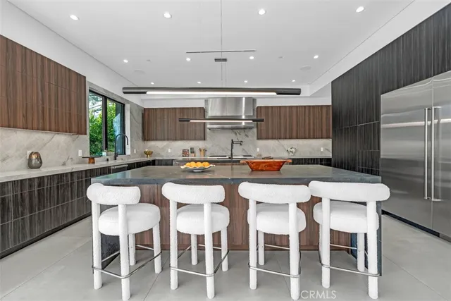 a kitchen with counter space dining table and chairs
