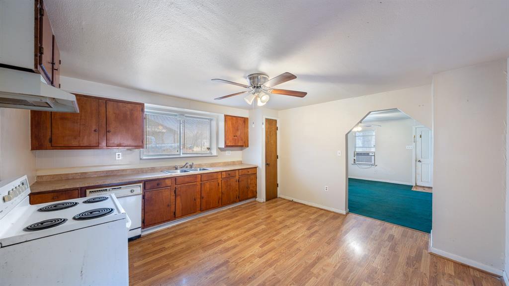 120 Davis Road Combine, TX 75159 - Photo 8 of 35 a kitchen with stainless steel appliances granite countertop a sink cabinets and wooden floor