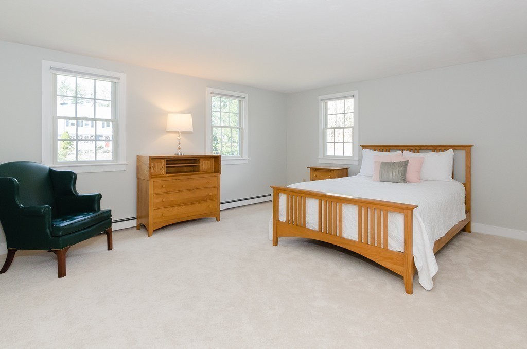 7 Ridgewood Lane Marion, MA 02738 - Photo 13 of 24 a bedroom with a bed and a couch next to a window