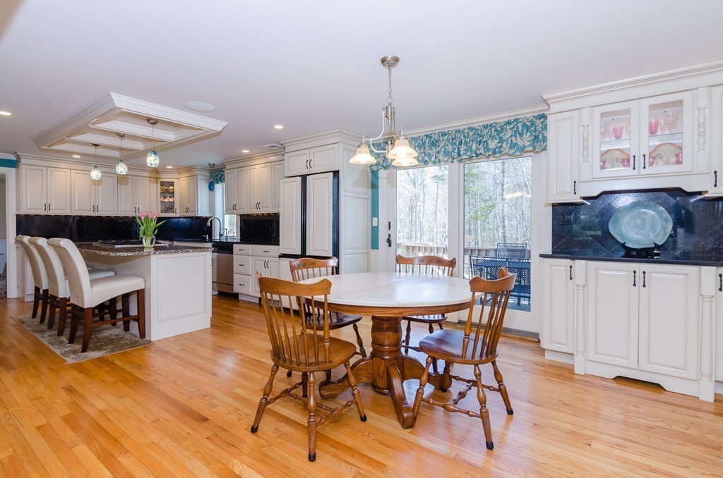 7 Ridgewood Lane Marion, MA 02738 - Photo 3 of 24 a dining room with furniture a chandelier and wooden floor