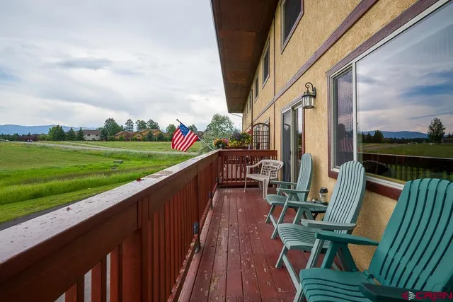 aerial view of a house with a yard and a lake view
